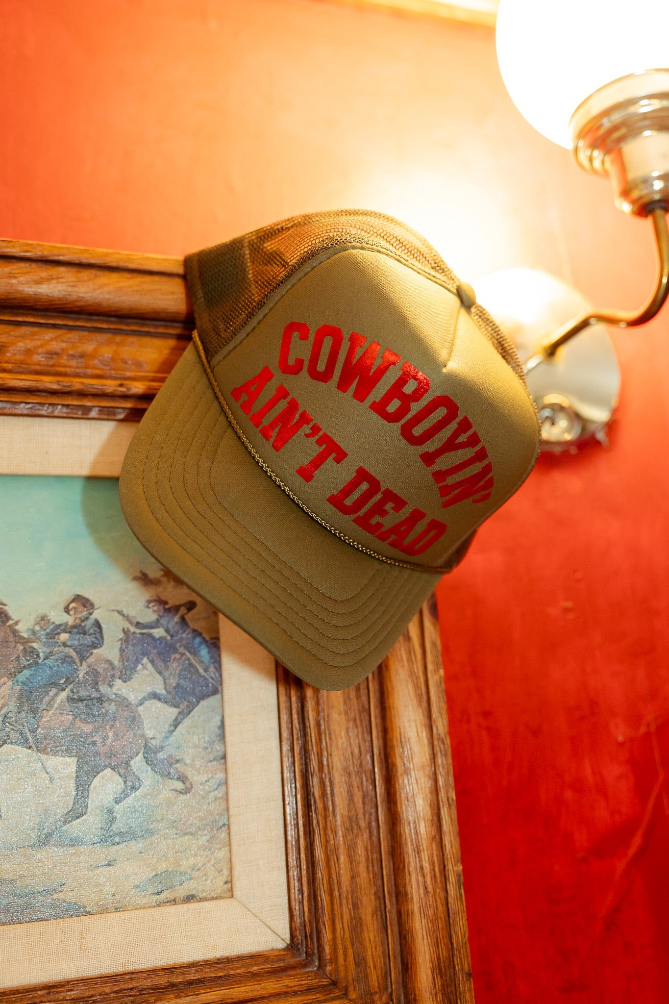 COWBOYIN' AIN'T DEAD TRUCKER HAT